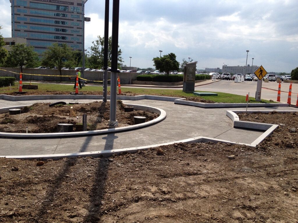 A construction worker is standing on a slab on deck concrete floor