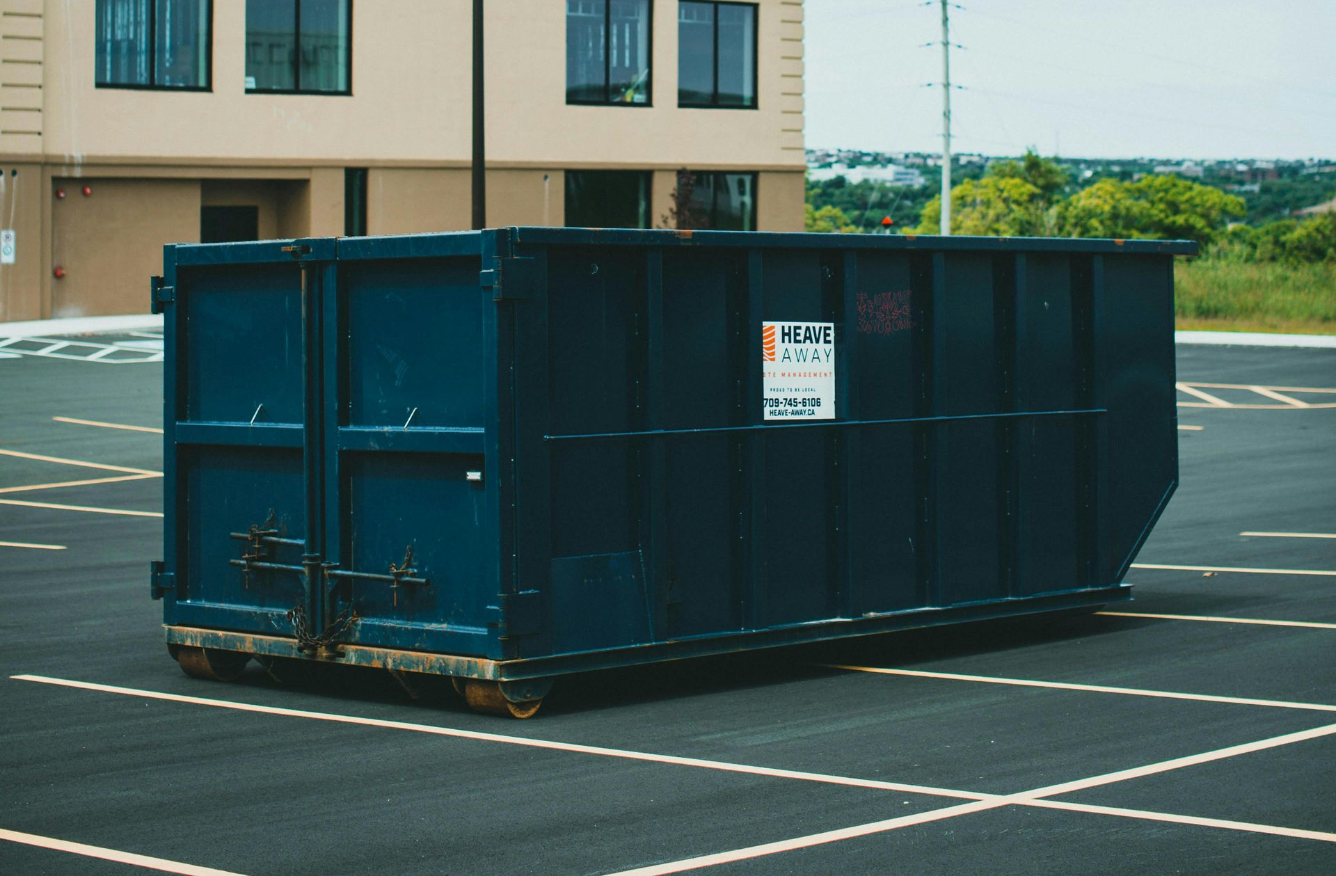 Dumpster in Lakeville, NY Parking Lot