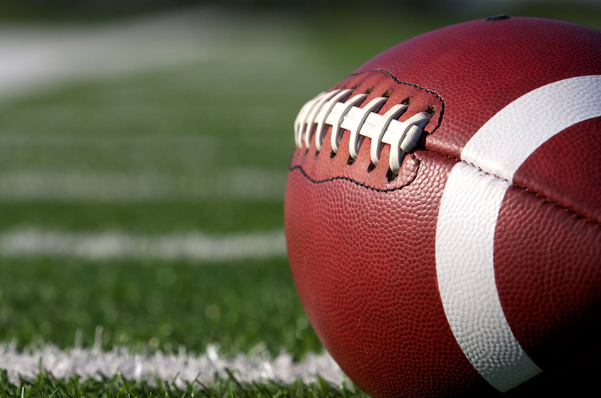 A close up of a football on a field.