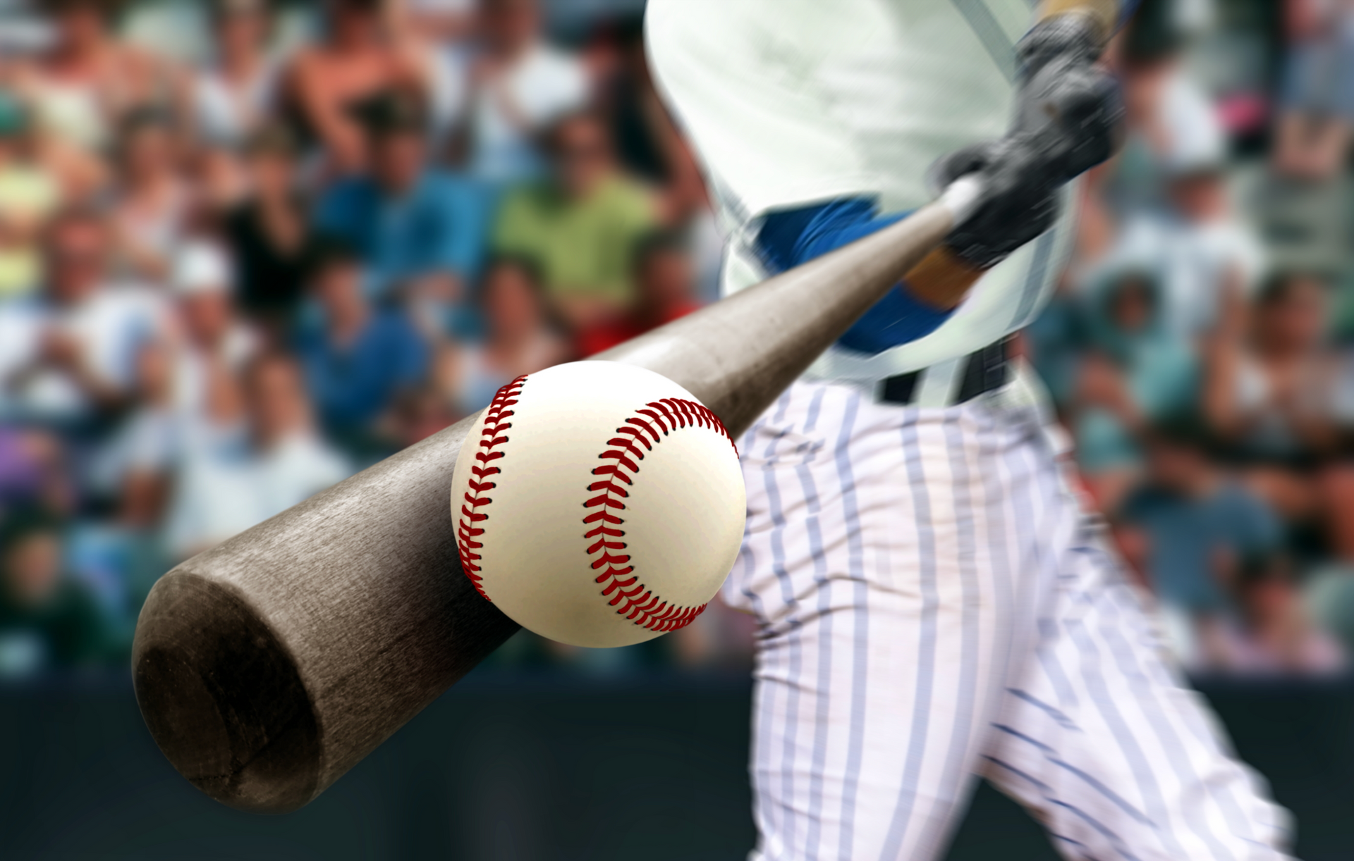A baseball player is holding a bat and a ball.