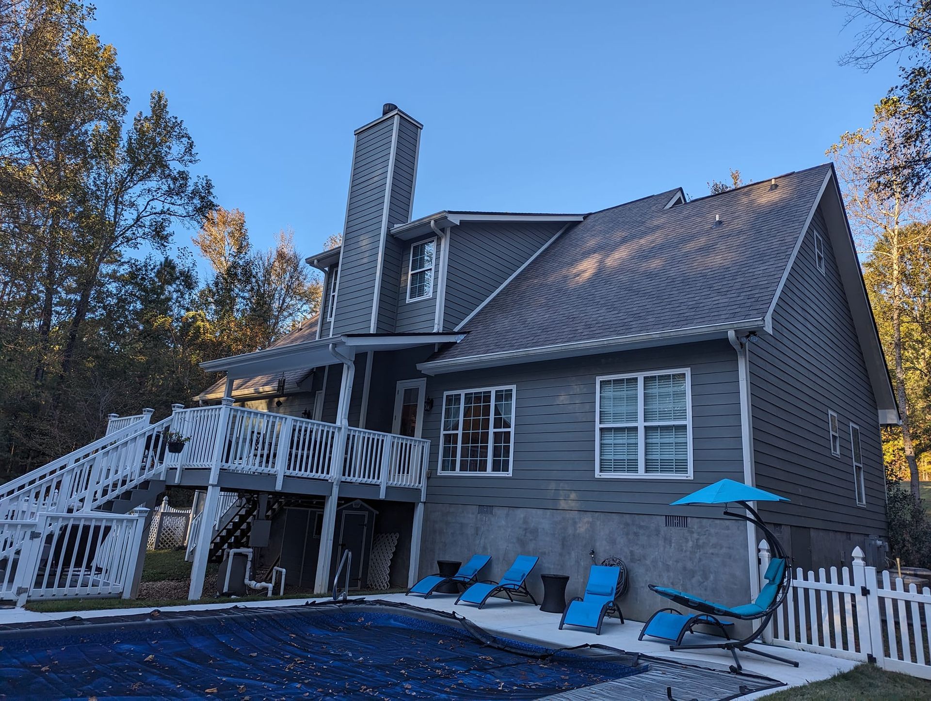 A large house with a swimming pool in front of it.