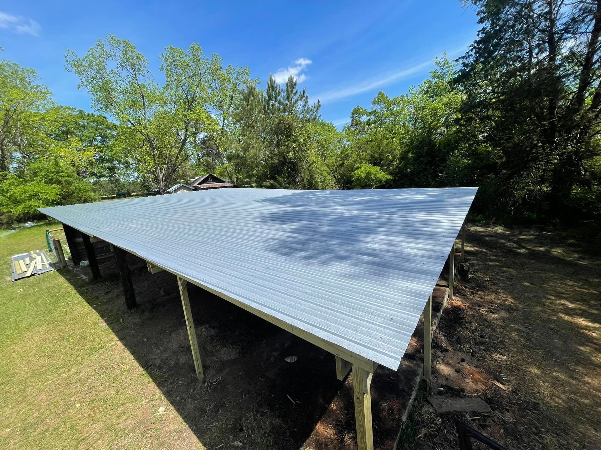 A metal roof is sitting on top of a wooden structure.