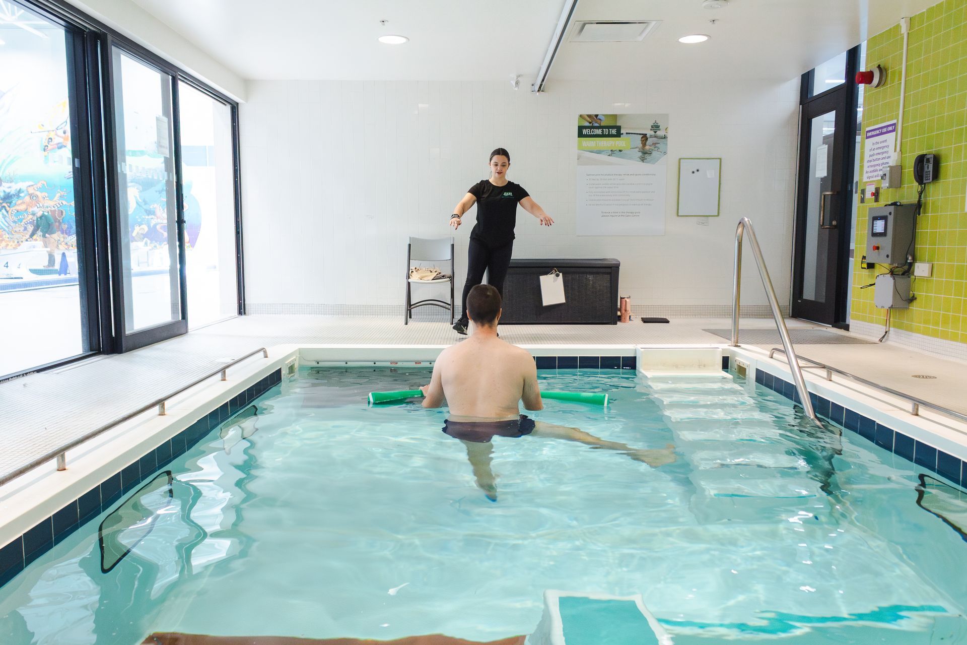 A group of people are holding dumbbells in a swimming pool.