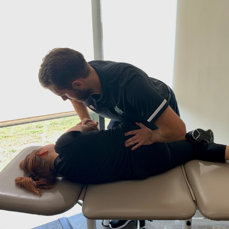 A woman is getting a massage from a doctor.