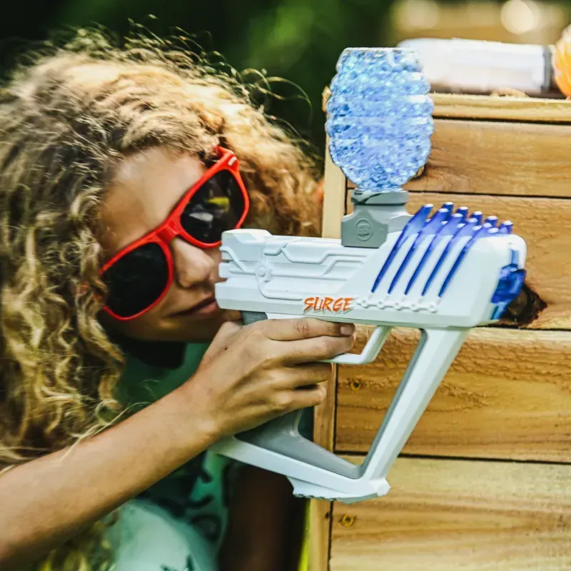 A group of paintball players are sitting on a truck and shaking hands.