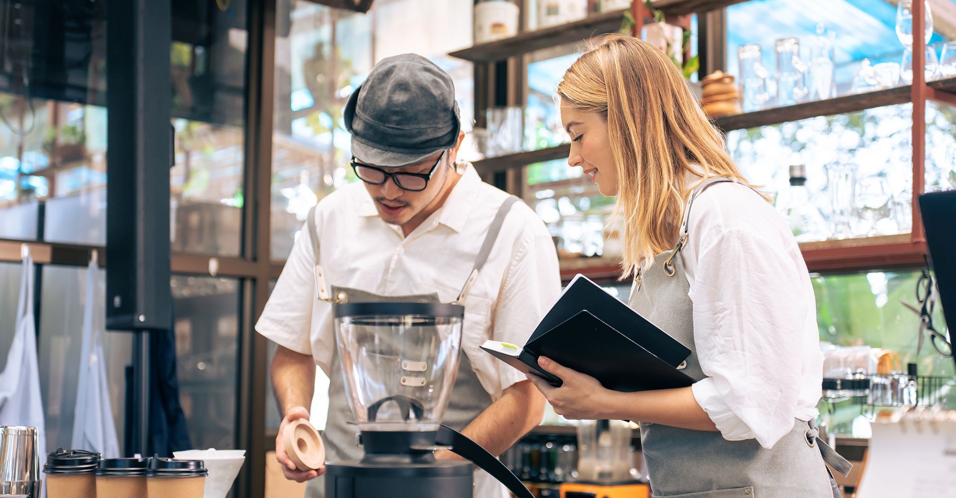 A man and a woman are standing next to each other in a kitchen.