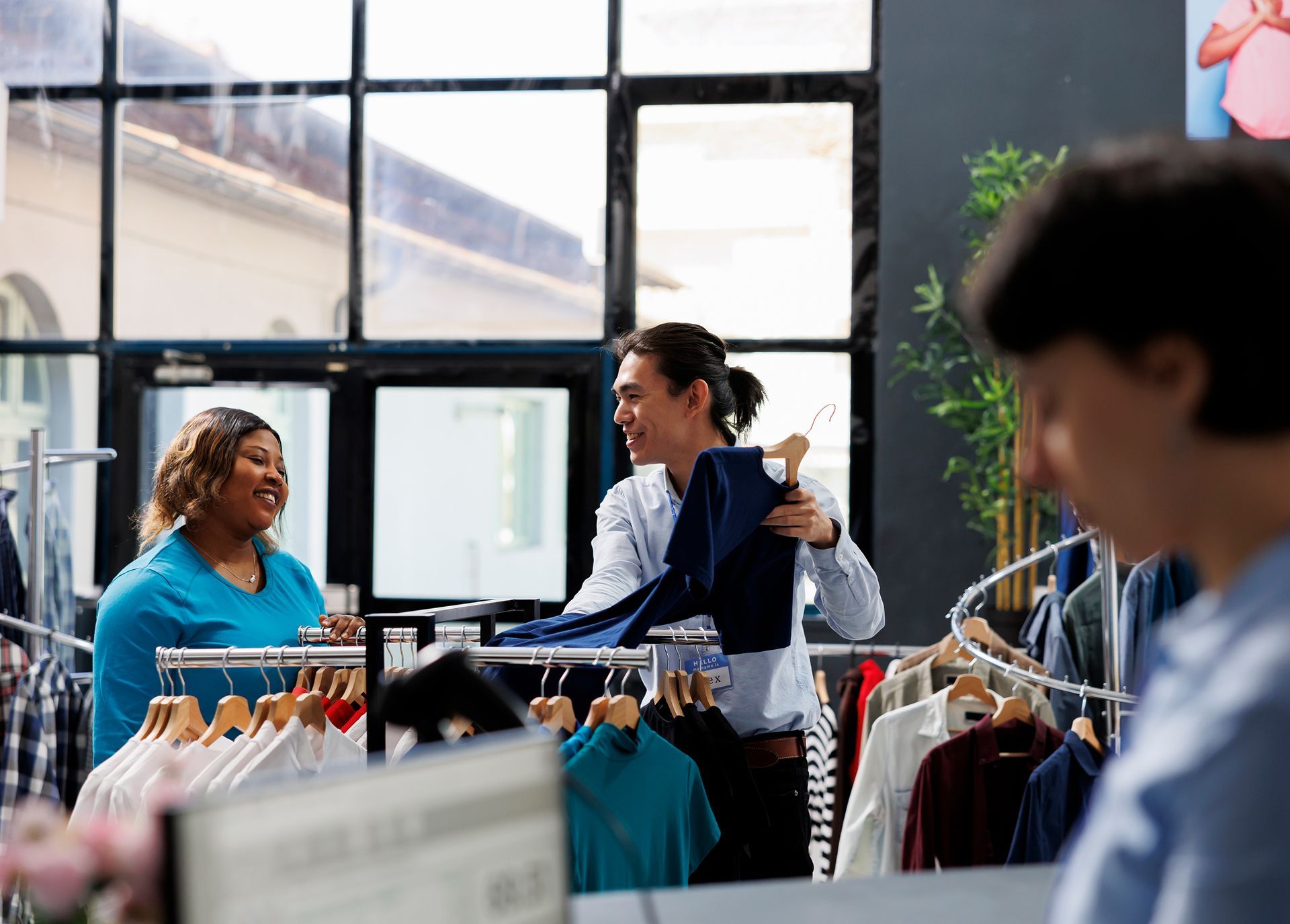 Two women are shopping in a clothing store.
