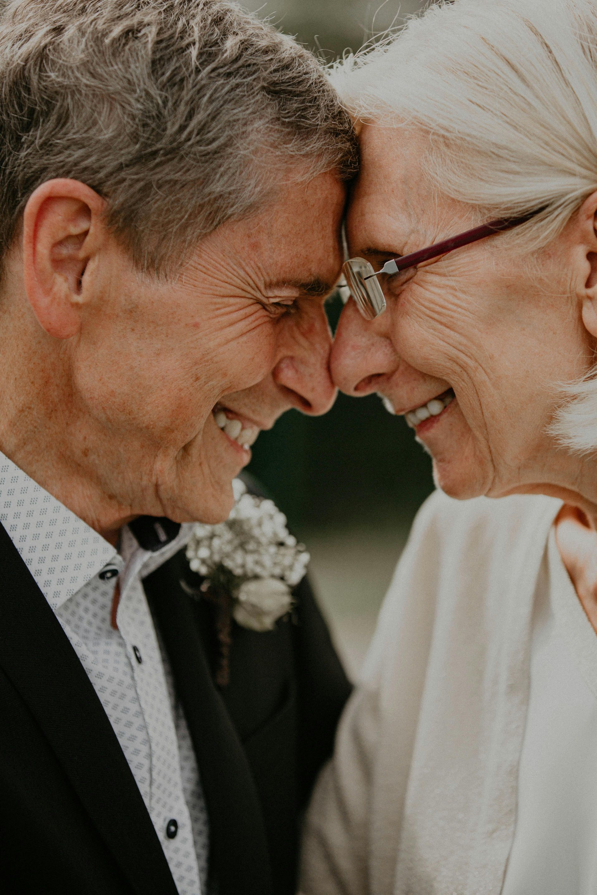 A man and a woman are looking at each other and smiling.