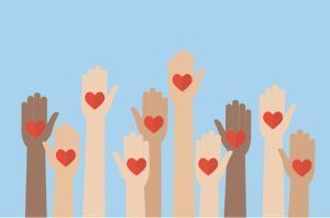 A group of people are raising their hands with hearts on them.