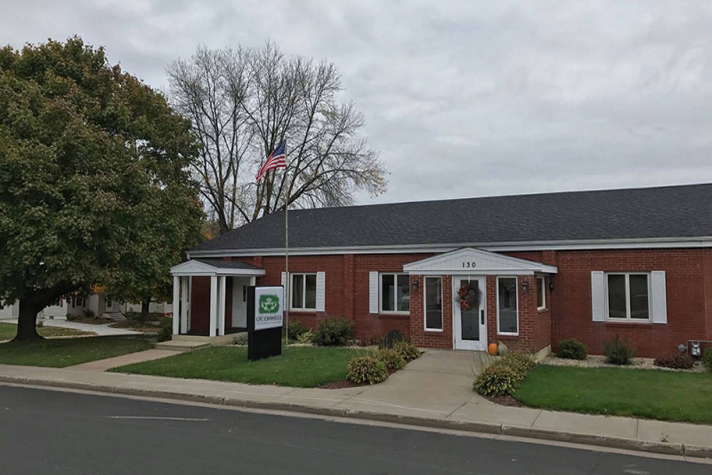 A brick building with a sign that says ' green ' on it