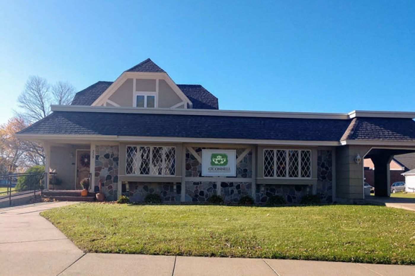 A large house with a lawn in front of it