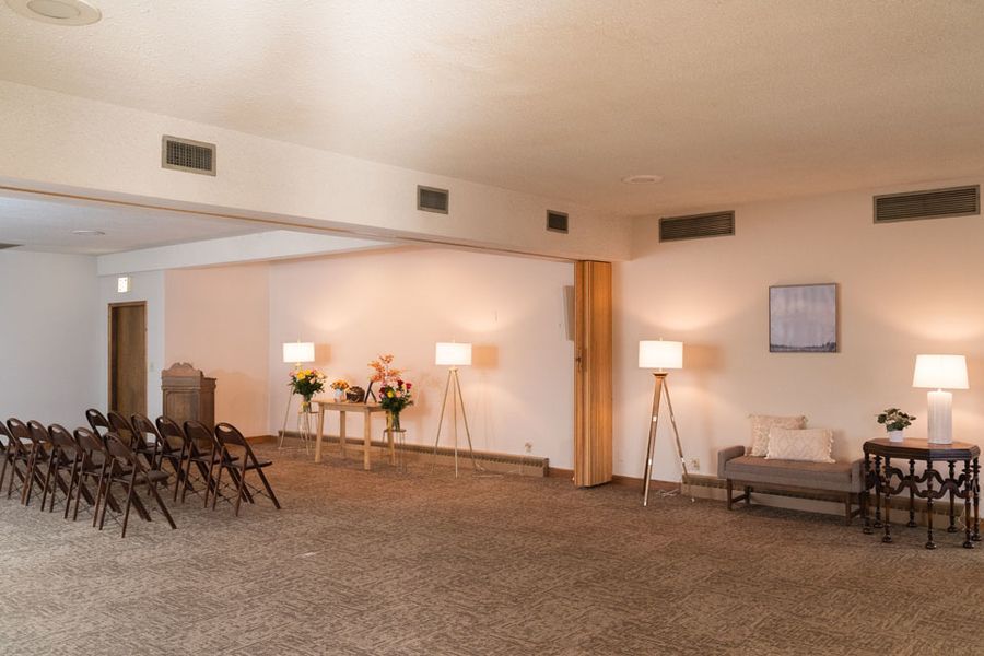 A large room with a lot of chairs and tables in it.