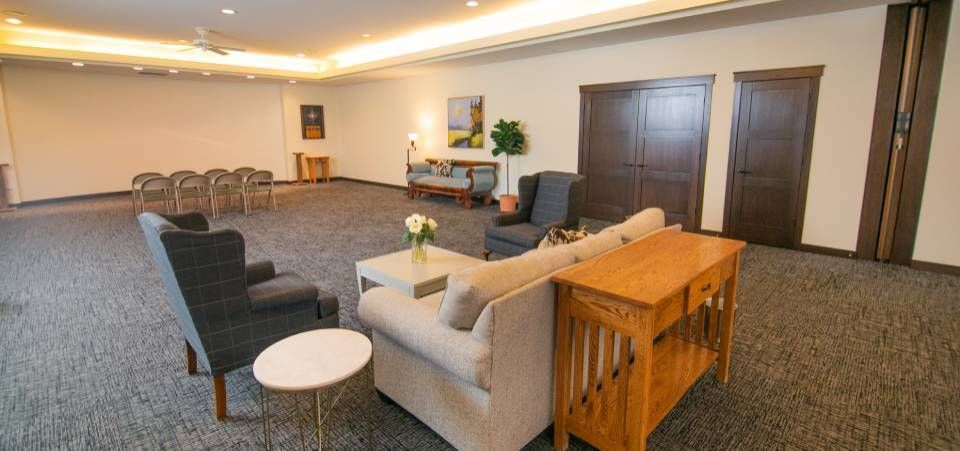 A living room with a couch , chairs , tables and a table.