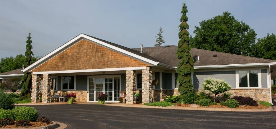 A large house with a lot of windows and trees in front of it