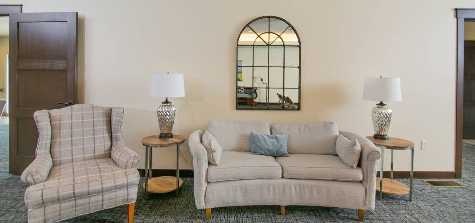 There is a couch and two chairs in the living room.