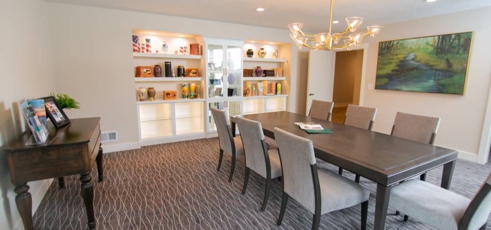 A dining room with a table and chairs and a chandelier.
