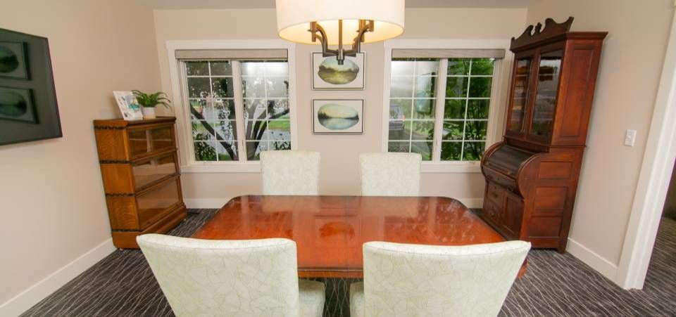 A dining room with a table and chairs and a chandelier.