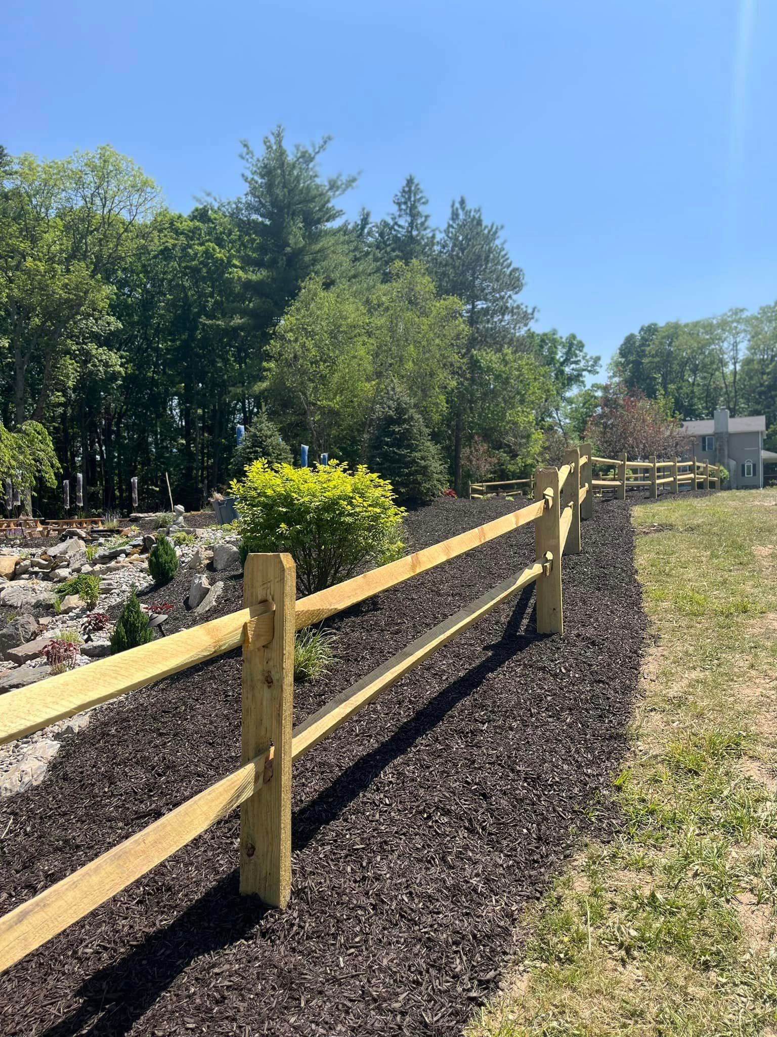 Landscaping by Tailored Excavation with trees in the background.