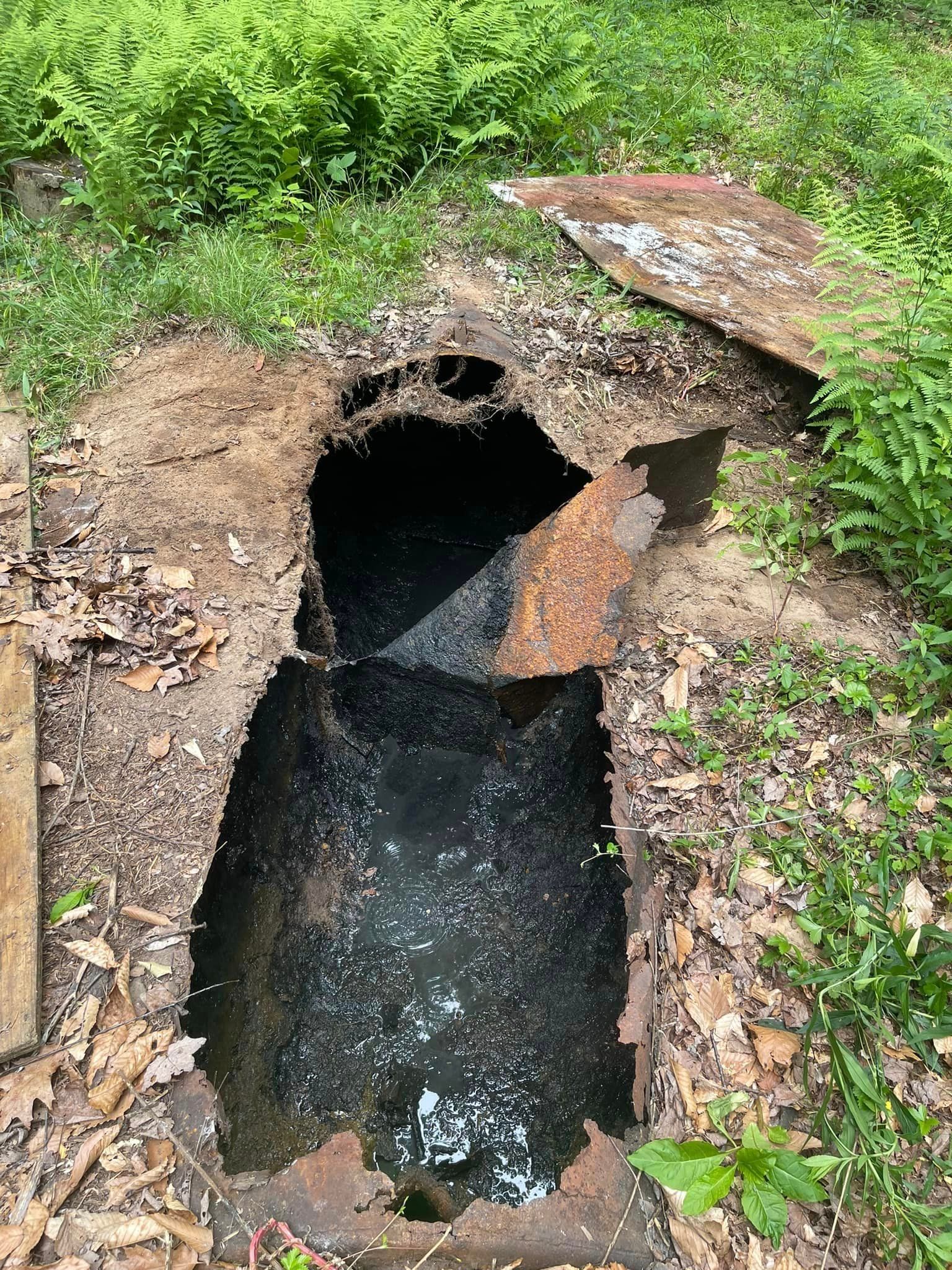 Old septic tank being taken out of the ground by Tailored Excavation