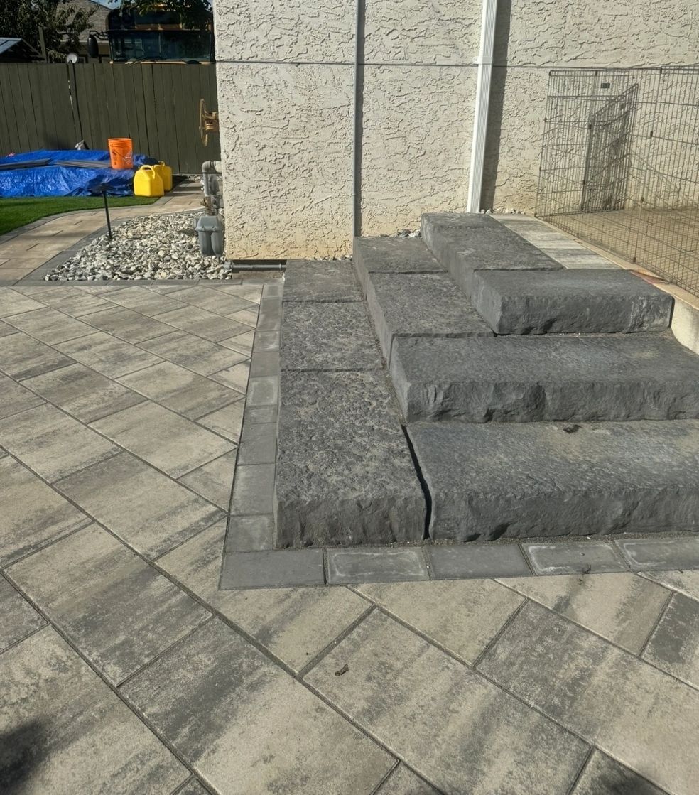 Stone steps leading up, surrounded by paved walkway.