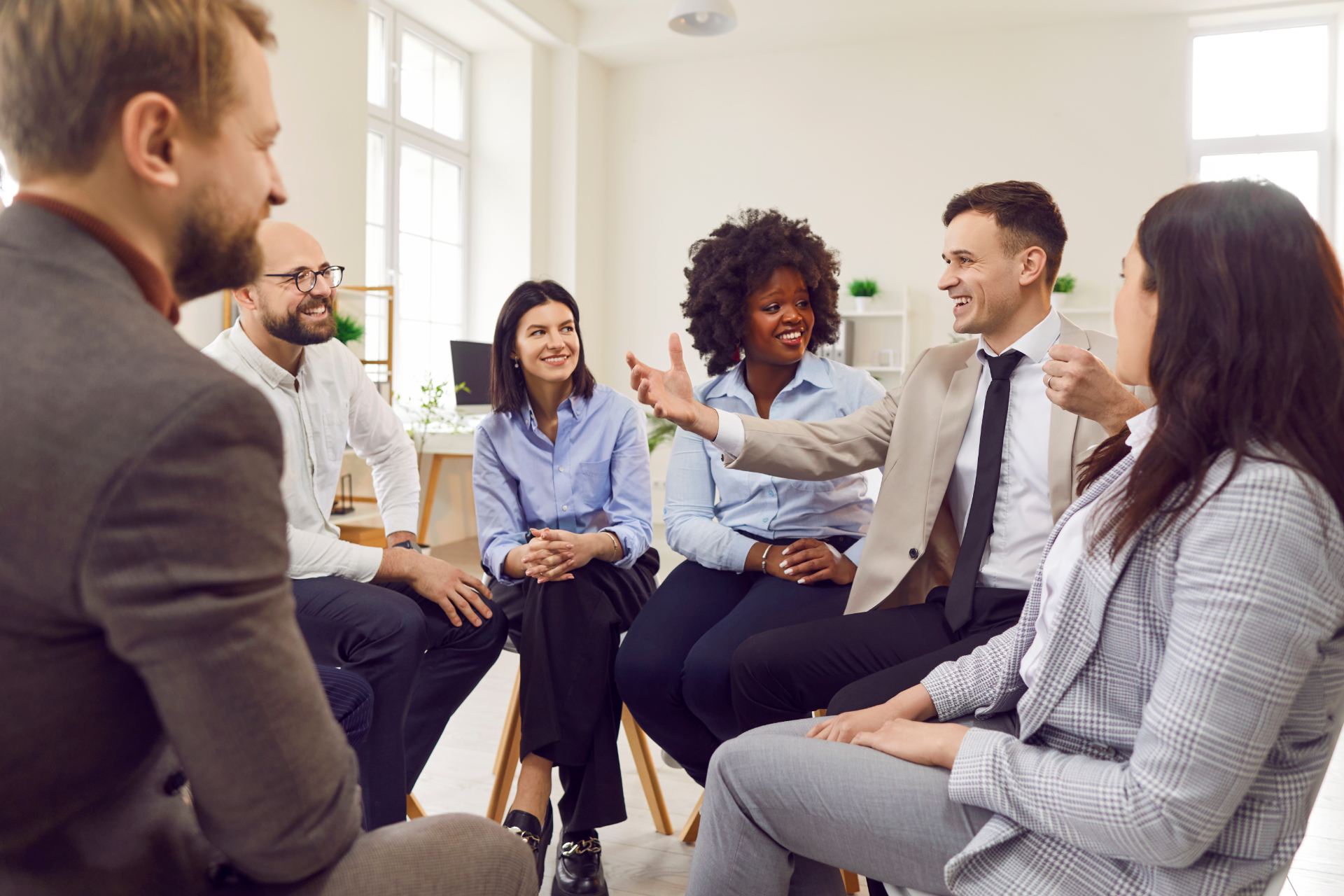 A man in a blue shirt and tie is using a laptop computer.