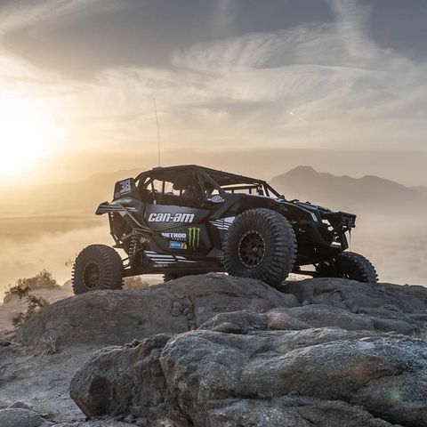 A can-am maverick x3r is parked on top of a rocky hill.