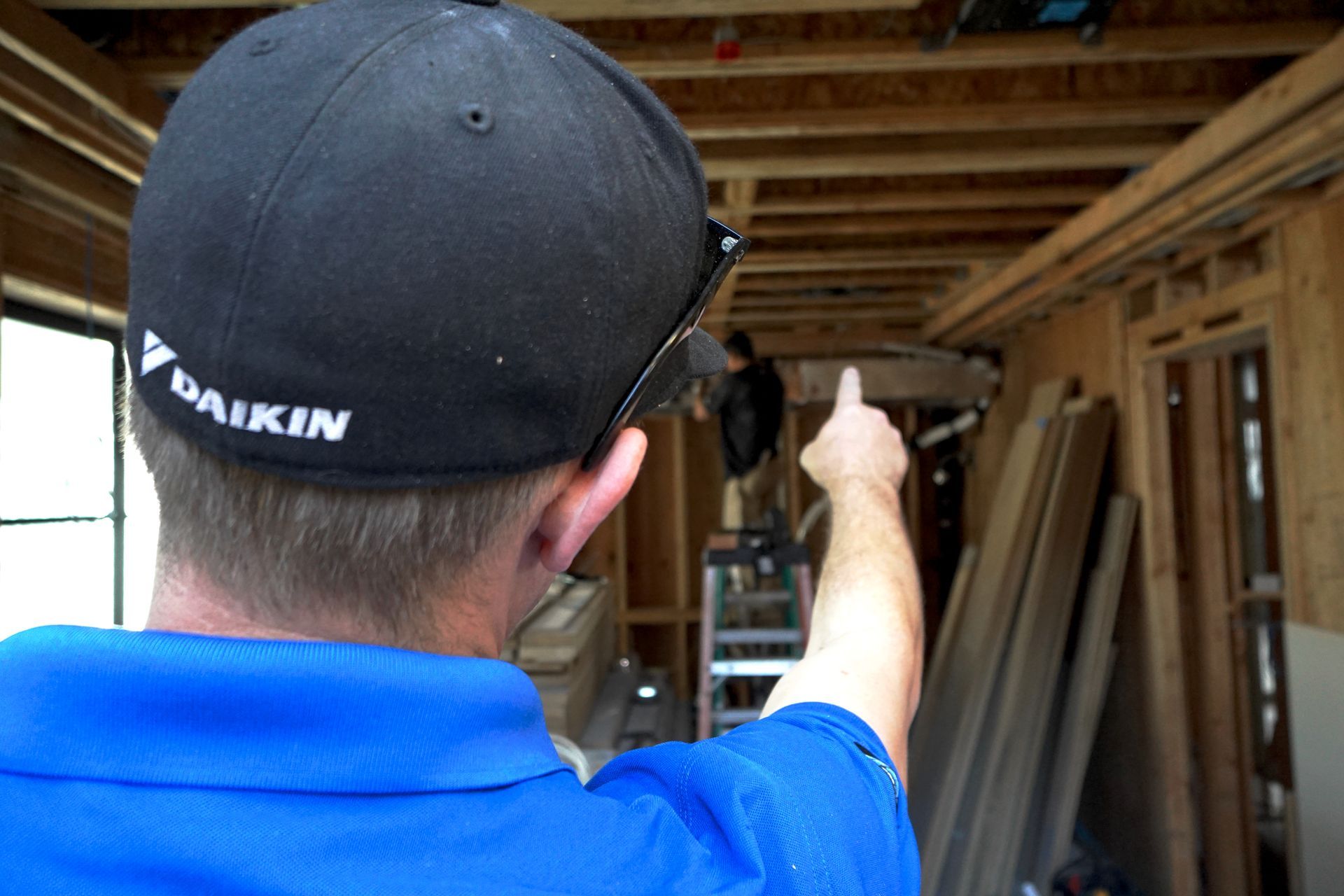 HVAC technician repairing rooftop air conditioning unit. Gray unit, person with tools.