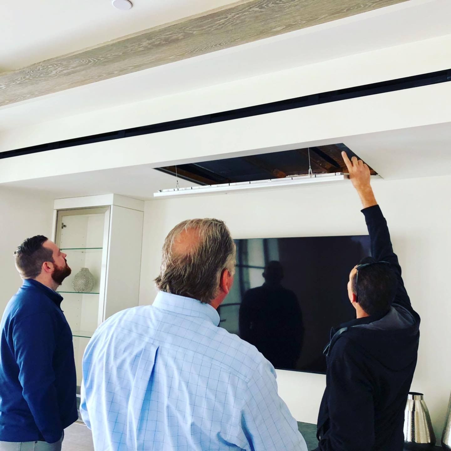 Construction workers and supervisor reviewing blueprints at a building site.