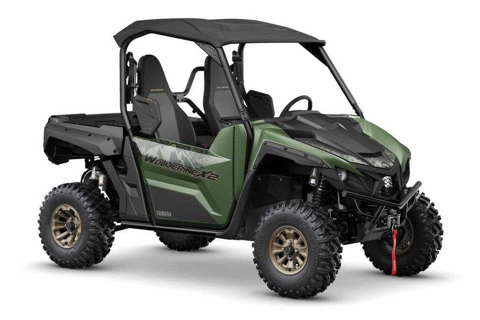 a green and black yamaha wolverine x2 utility vehicle