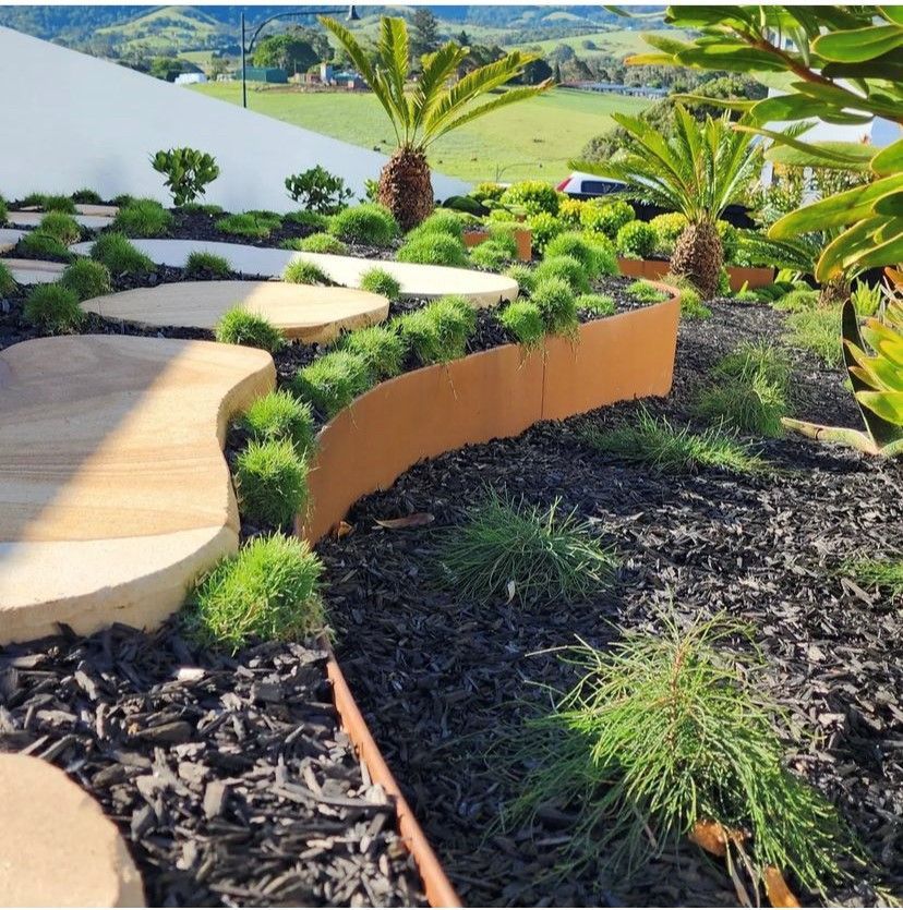 A lush green garden with a wooden walkway