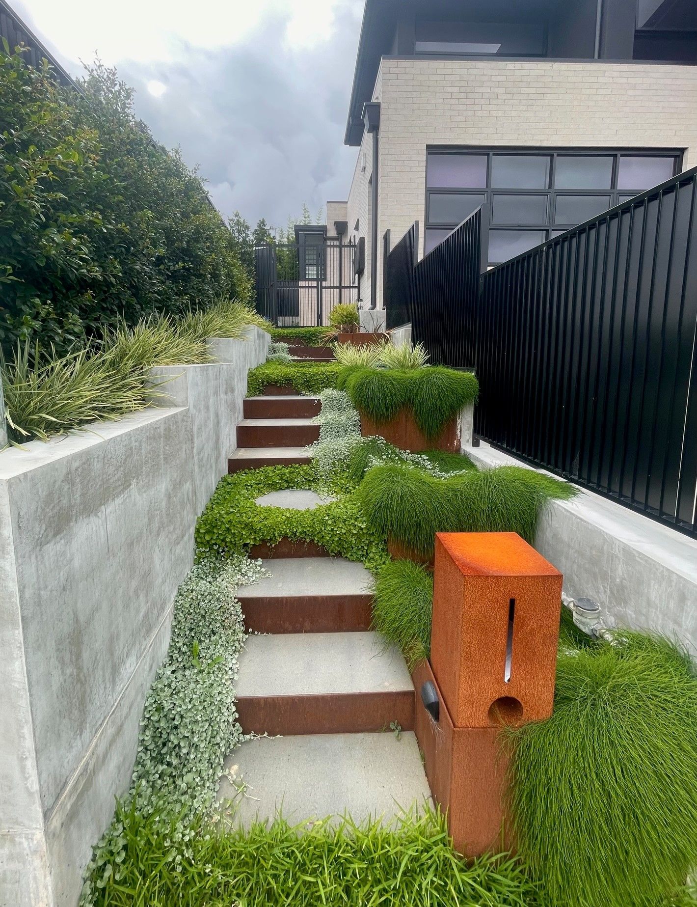 A row of stairs leading up to a house surrounded by grass.