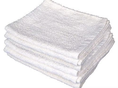 A stack of white towels stacked on top of each other on a white background.