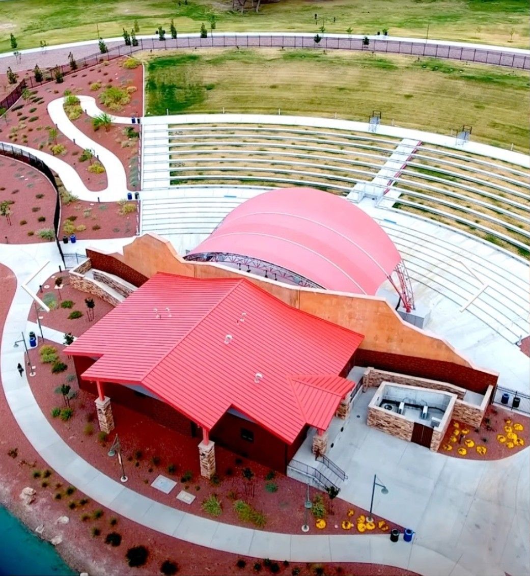 A crowd of people are standing in front of a stage at a concert.