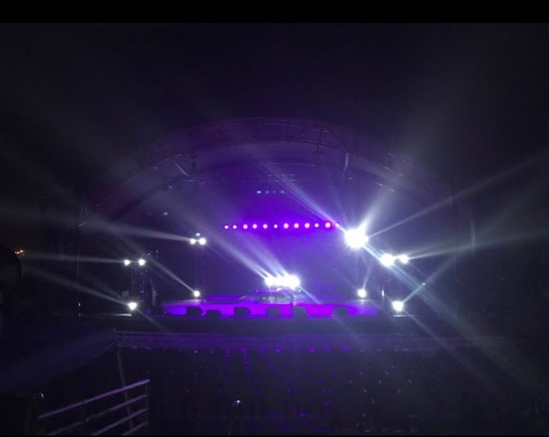 A man and a woman are standing in front of a coffee truck.