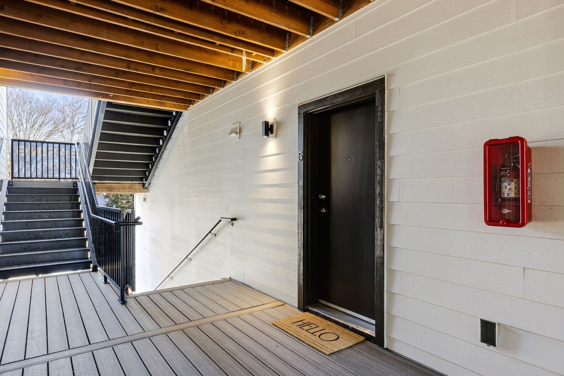 There is a fire extinguisher on the wall next to the door.