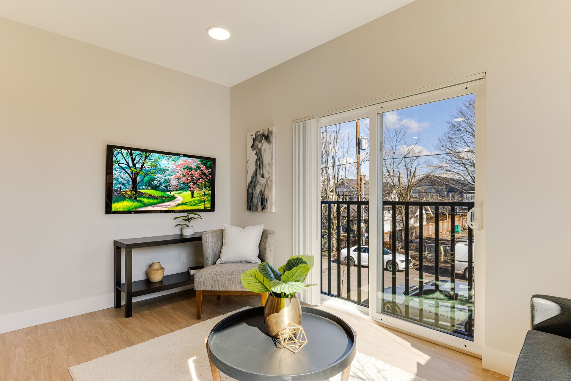 A living room with a couch , chair , table and television.