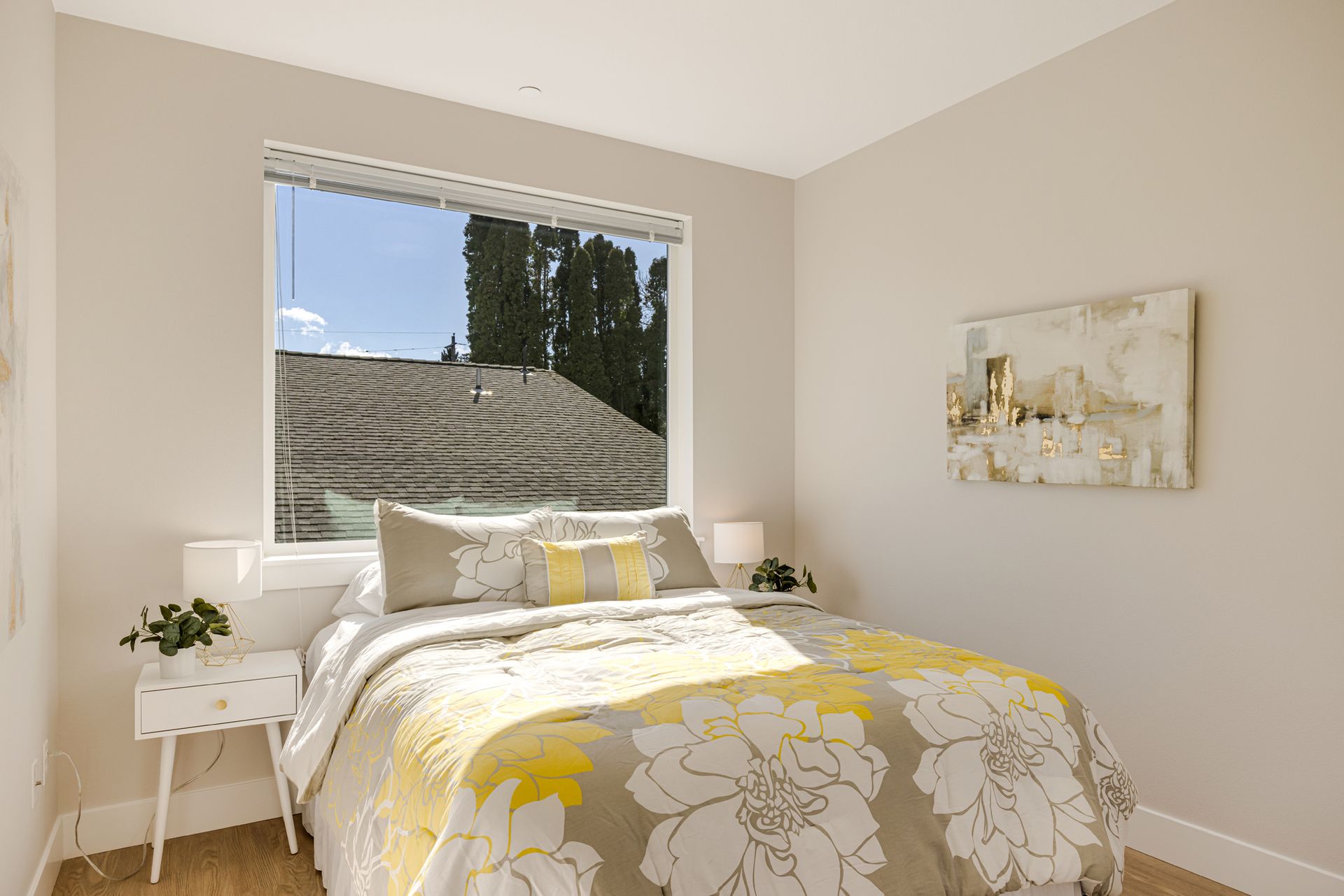 A bedroom with a bed , nightstand , and window.