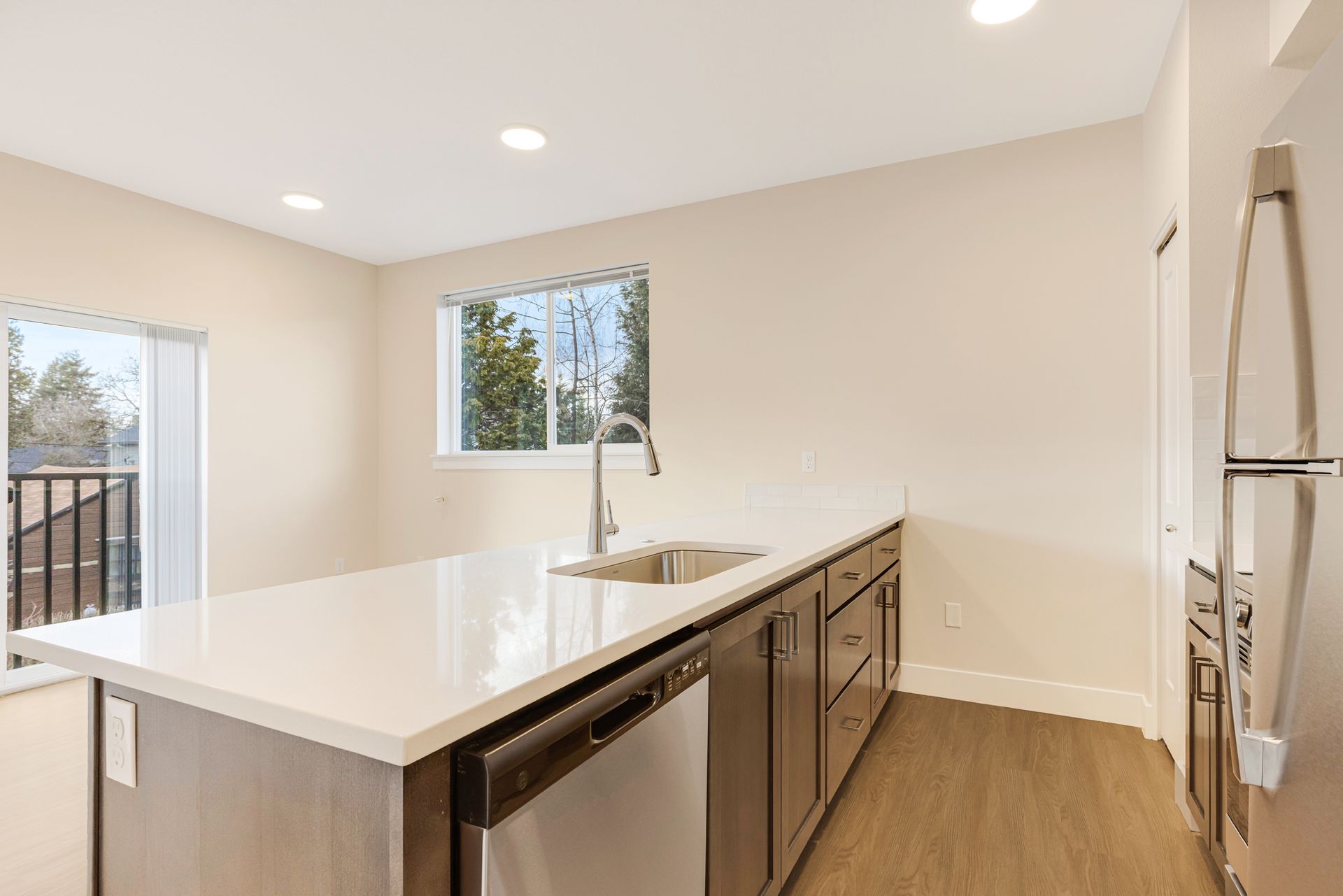 A kitchen with stainless steel appliances and a large island.