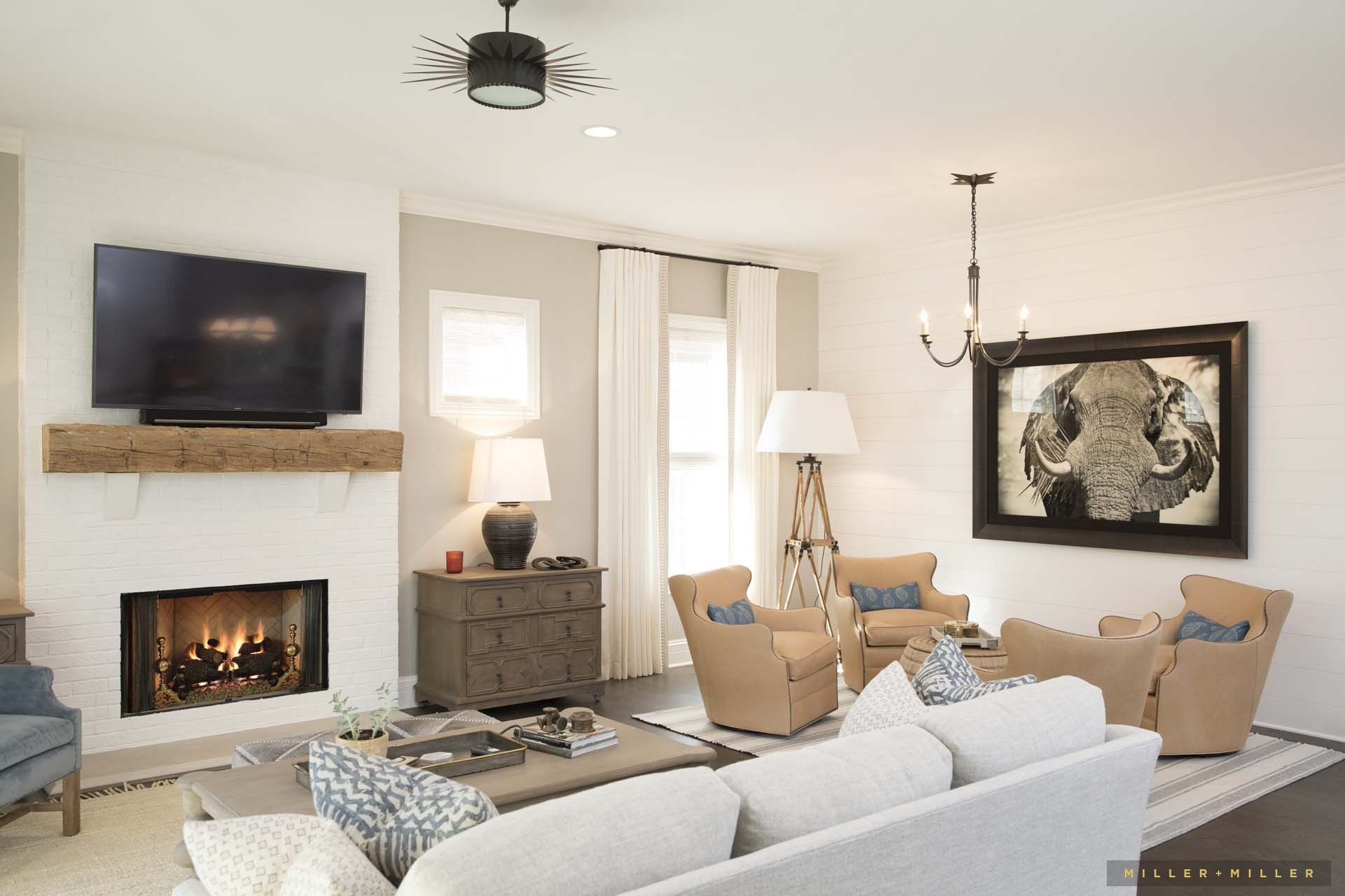 A living room with a fireplace and a flat screen tv