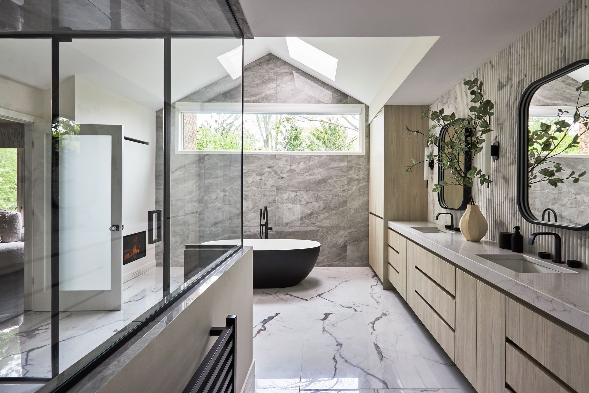 A bathroom with a bathtub , sink , mirror and walk in shower.