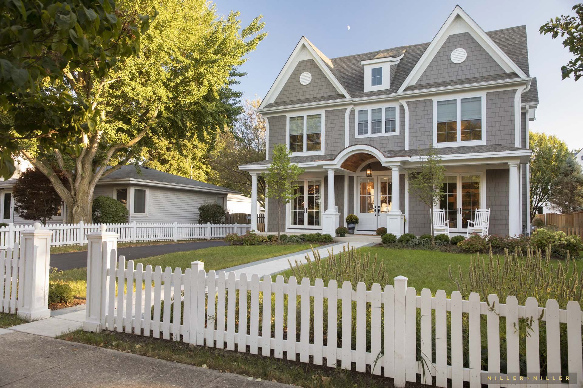 A large house with a white picket fence around it