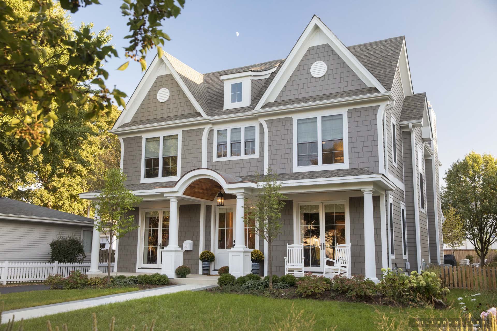 A large house with a lot of windows and a porch