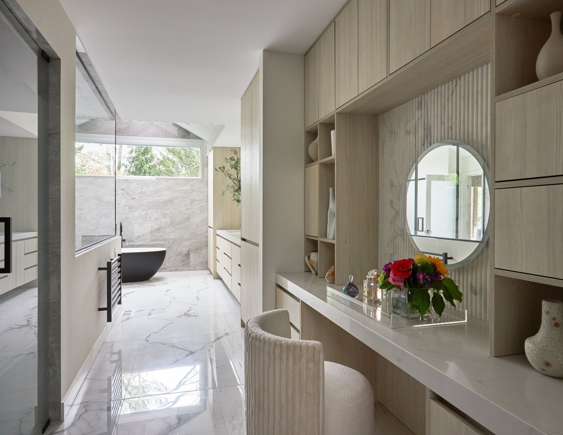 A bathroom with a vanity , chair , mirror and tub.