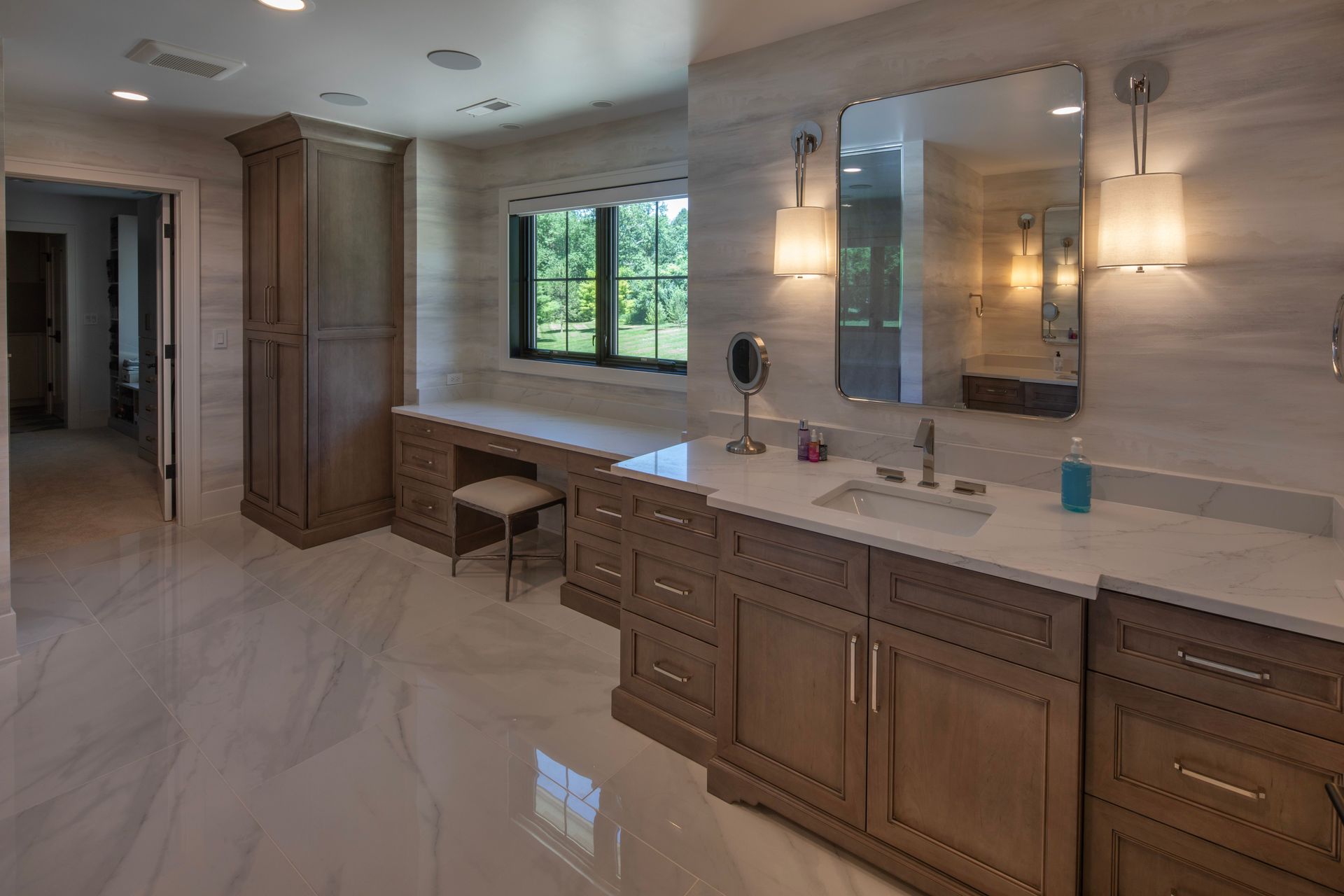 A bathroom with two sinks , a vanity , and a mirror.