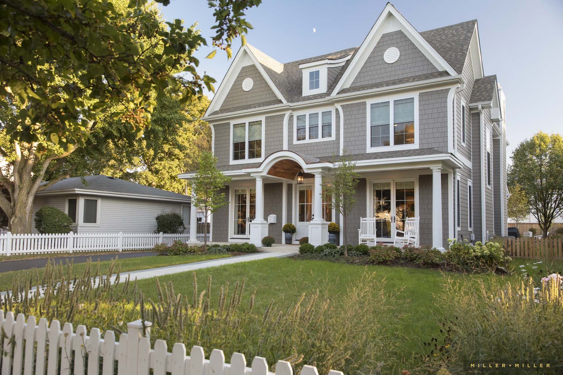A large house with a white picket fence in front of it