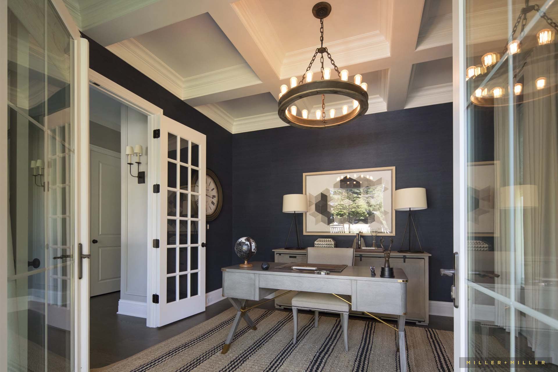 A home office with a desk and a clock on the wall