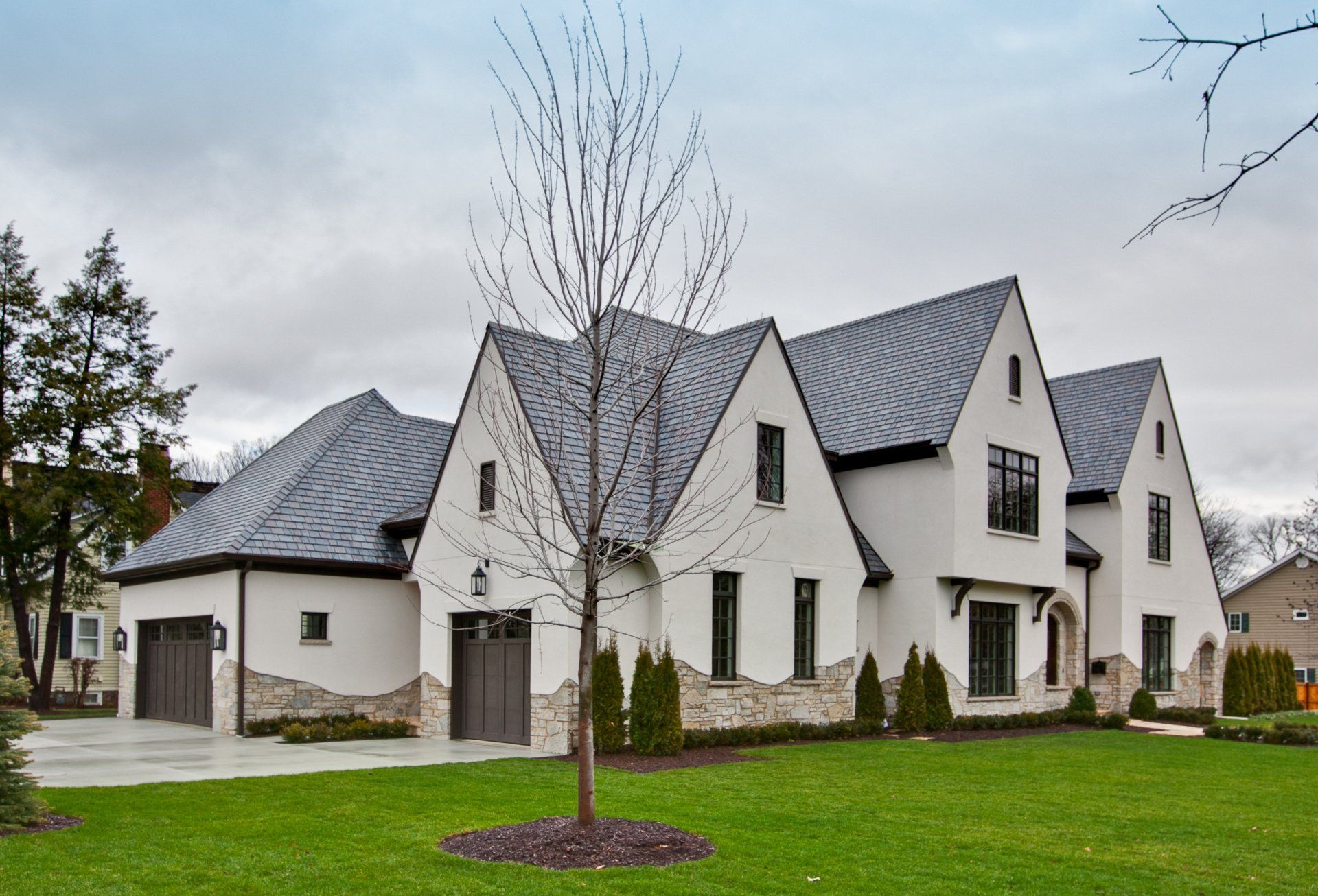 A large white house with a tree in front of it