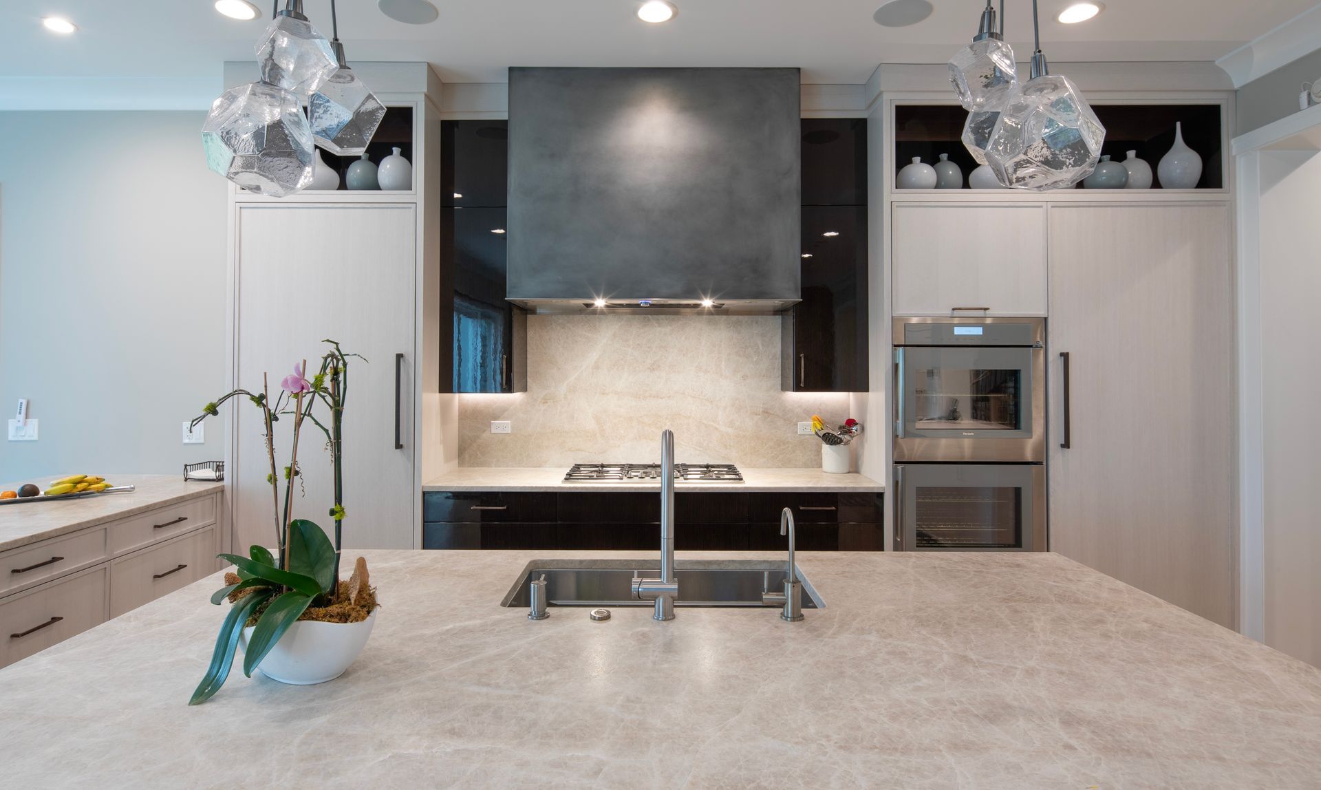 A kitchen with a sink , stove , and refrigerator.