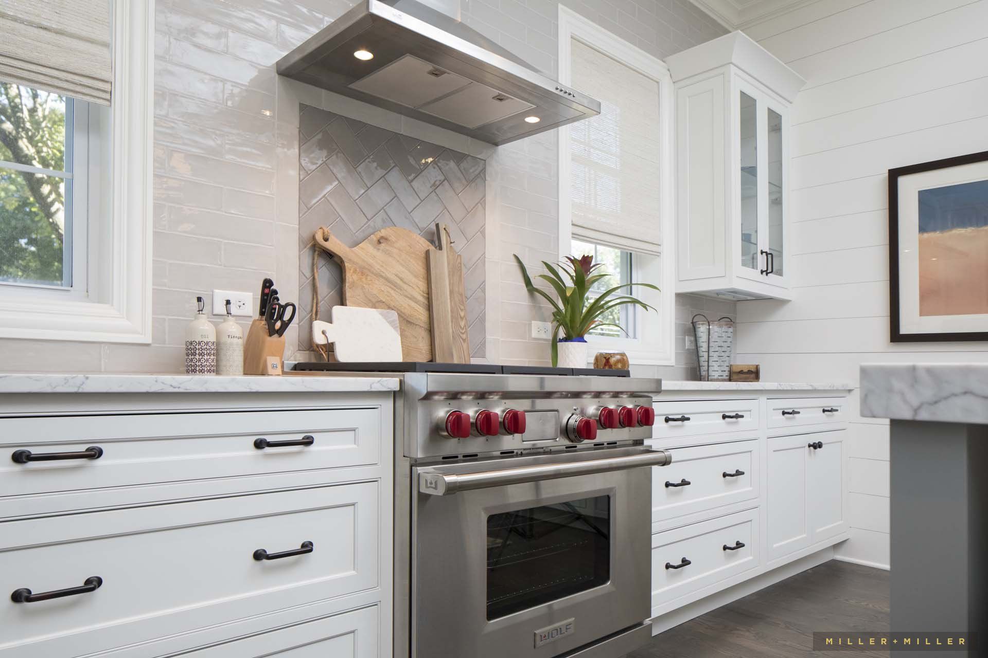 A kitchen with stainless steel appliances and white cabinets