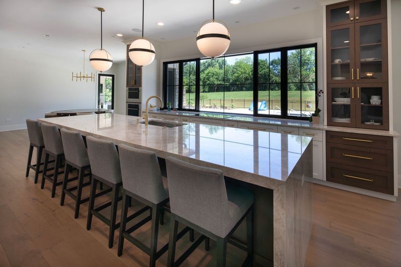 A kitchen with a large island and stools